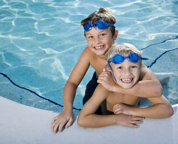 Child-learning-to-swim-with-instructor-in-pool)