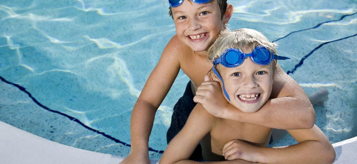 Child-learning-to-swim-with-instructor-in-pool)